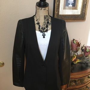 Black jacket with faux leather sleeves.